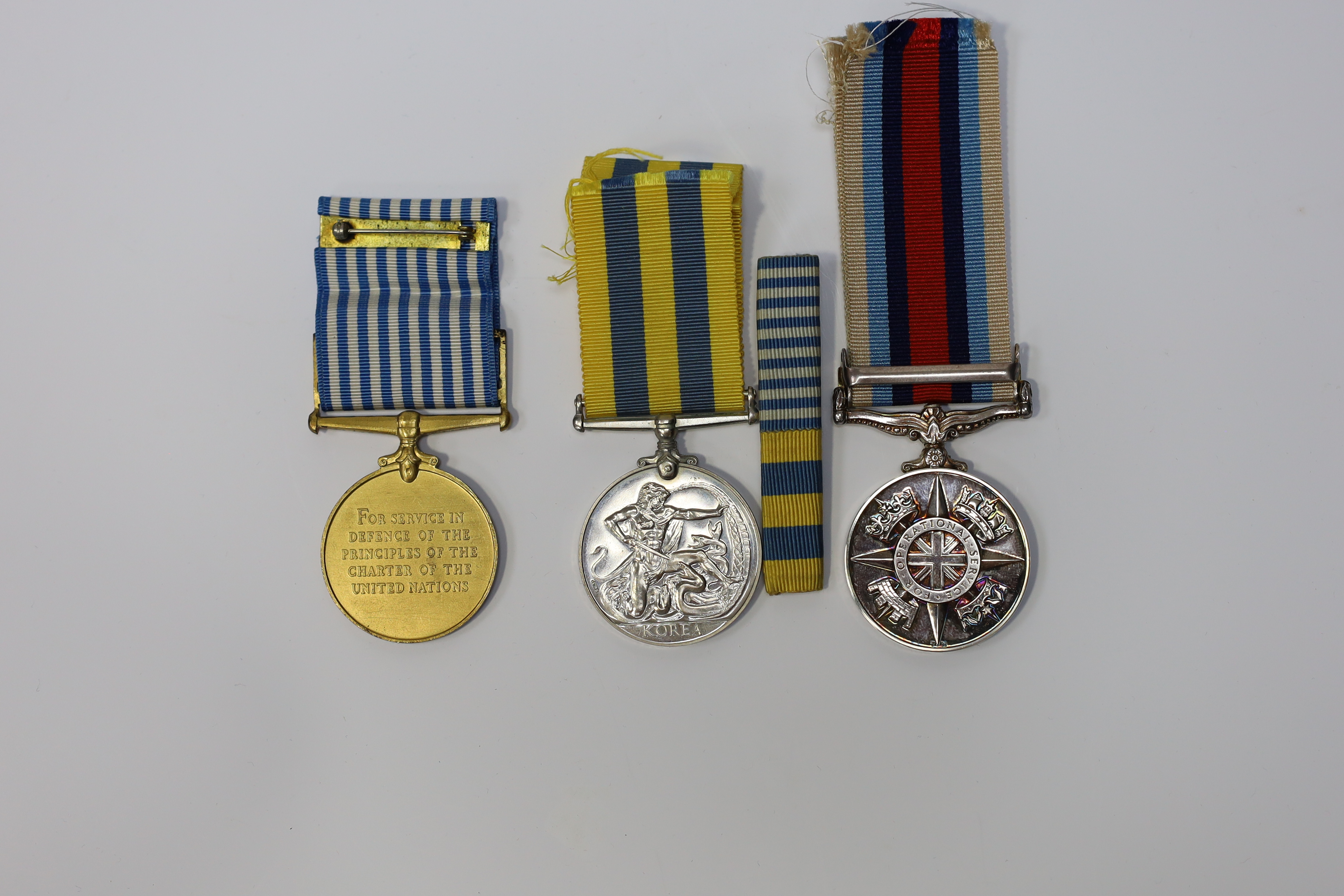 An ERII Operational Service Medal for Afghanistan awarded to Sgt. A.J. Pugsley RAMC (R), together with a Korea medal pair awarded to Sigmn. A.G. Lickman R.Sigs., all in separate issue boxes. Condition - fair to good